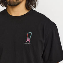 Load image into Gallery viewer, A close-up of a man wearing a black short-sleeve t-shirt with a small chest graphic. The graphic features a pink ribbon integrated with a teal and red climbing carabiner, with the word 'REVOLUTION' printed below in white.